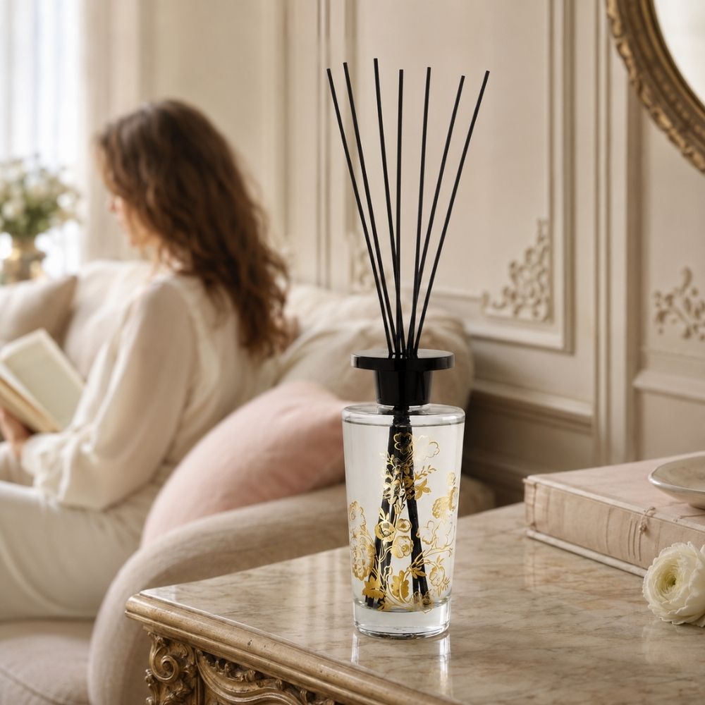 Ambientador mikado Trésor de Fleurs Marquise Mathilde M sobre mesa de centro en un salón acogedor con lectura de fondo – D'Arome
