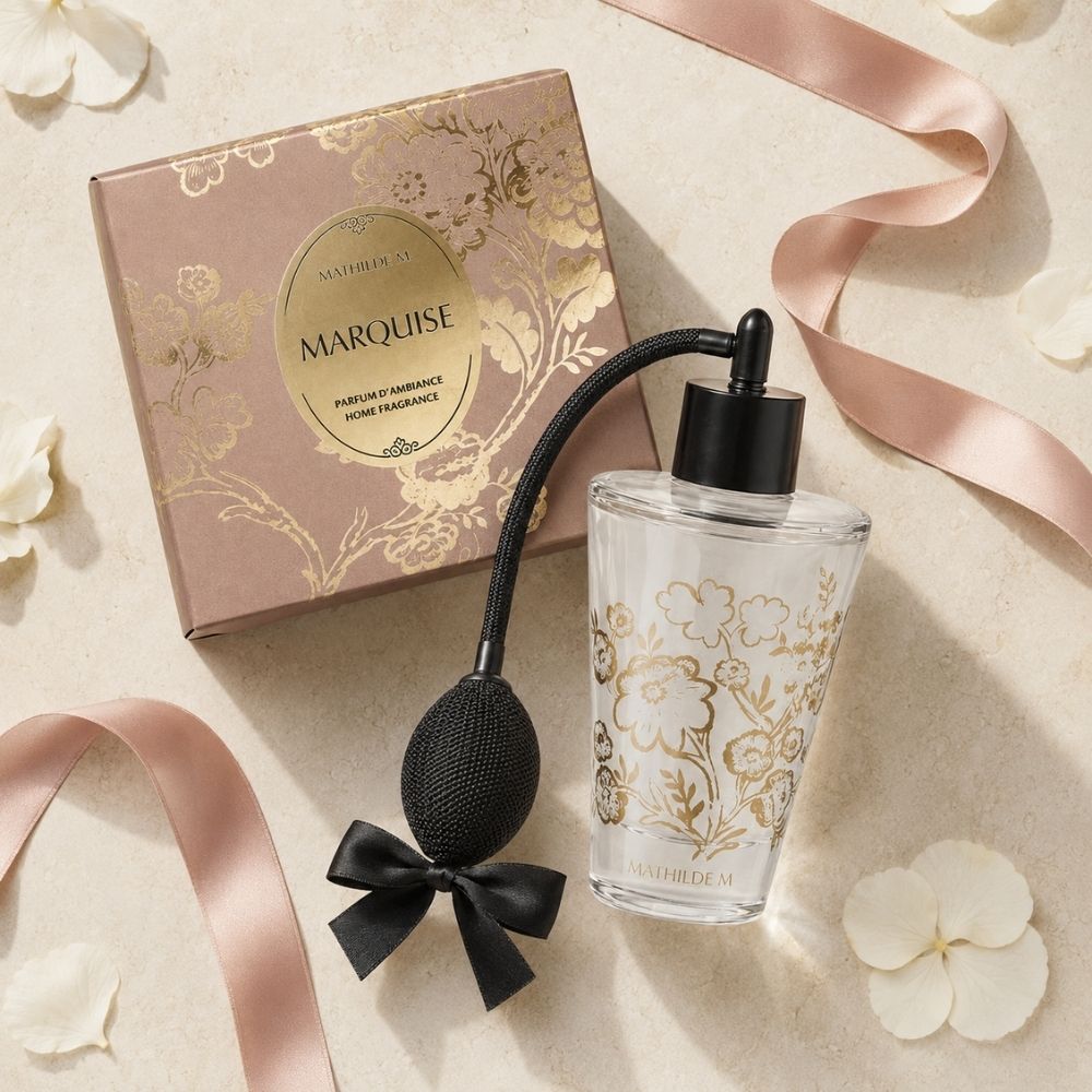 Ambientador spray vintage Trésor de Fleurs del aroma Marquise de Mathilde M junto a su caja rosa con motivos dorados, cintas de raso y pétalos – D'Arome