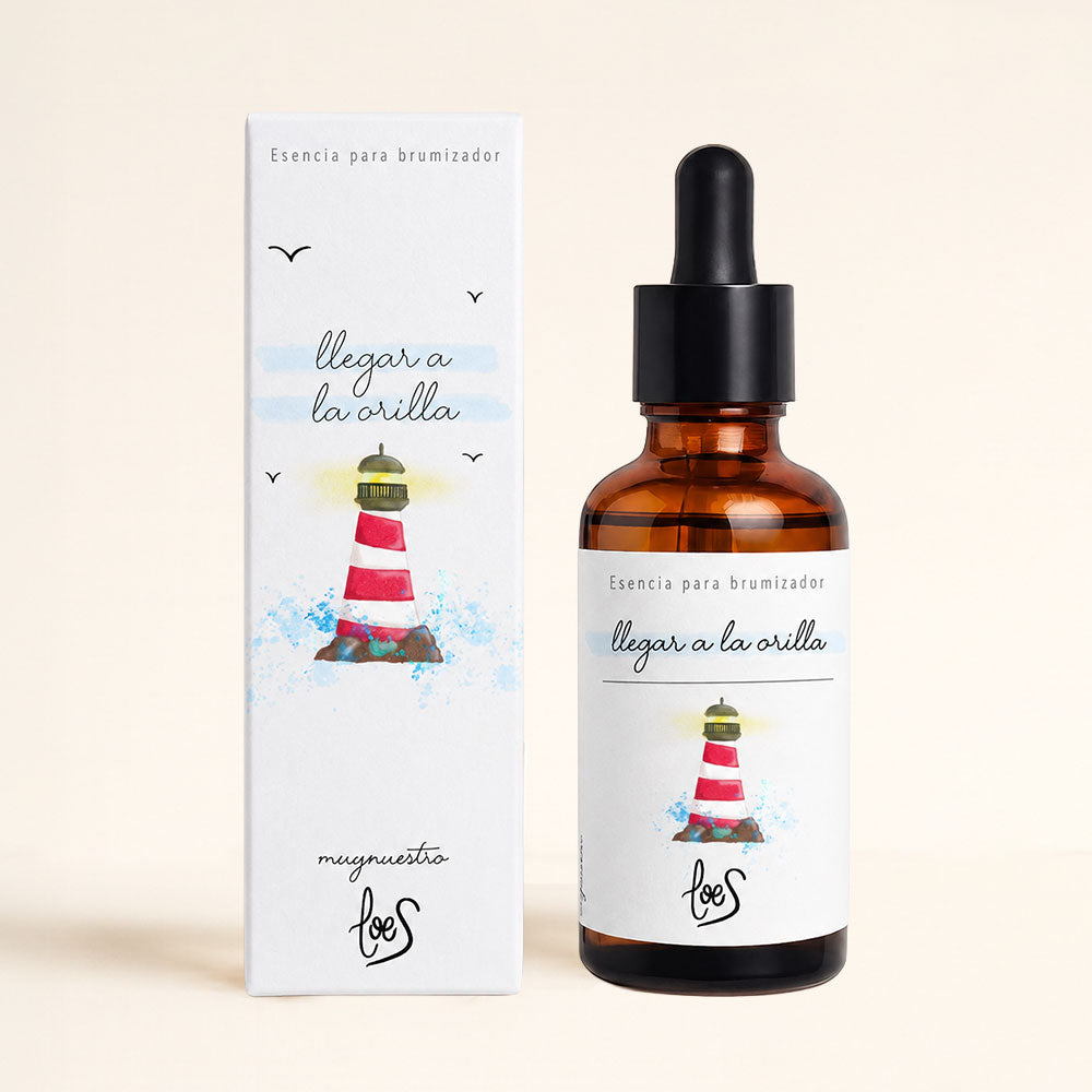 Esencia para difusor de aromas "Llegar a la orilla" de LoeS, frasco ámbar con cuentagotas y caja ilustrada con faro acuarela, aroma marino con notas frescas que evoca la calma de las personas faro – D'Arome