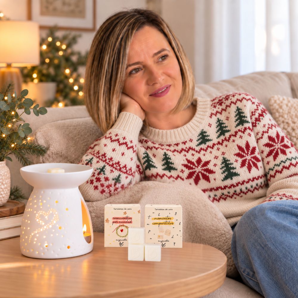 Ana Belén, fundadora de D'Arome, en el sofá junto al quemador Corazón encendido con una porción de cera perfumada LoeS – D'Arome