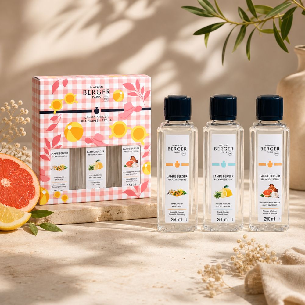 Trio Pack Estivale Maison Berger con caja y recargas rodeado de cítricos y ramas de olivo sobre piedra natural