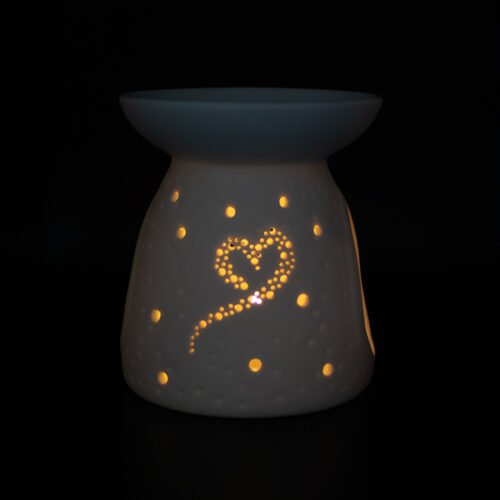 Quemador corazón con la luz encendida con un diseño de un corazón y de puntos de lado marca LoeS D'Arome